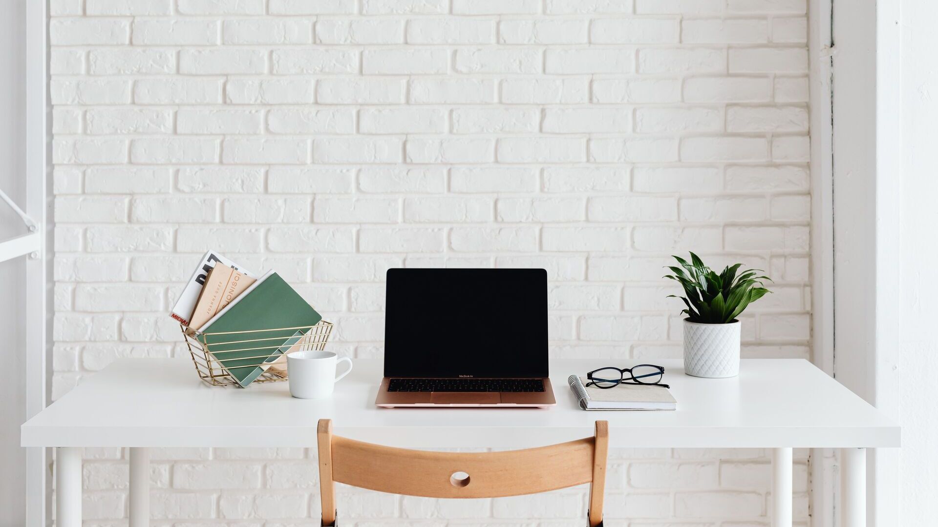 Office work space in front of a white brick wall